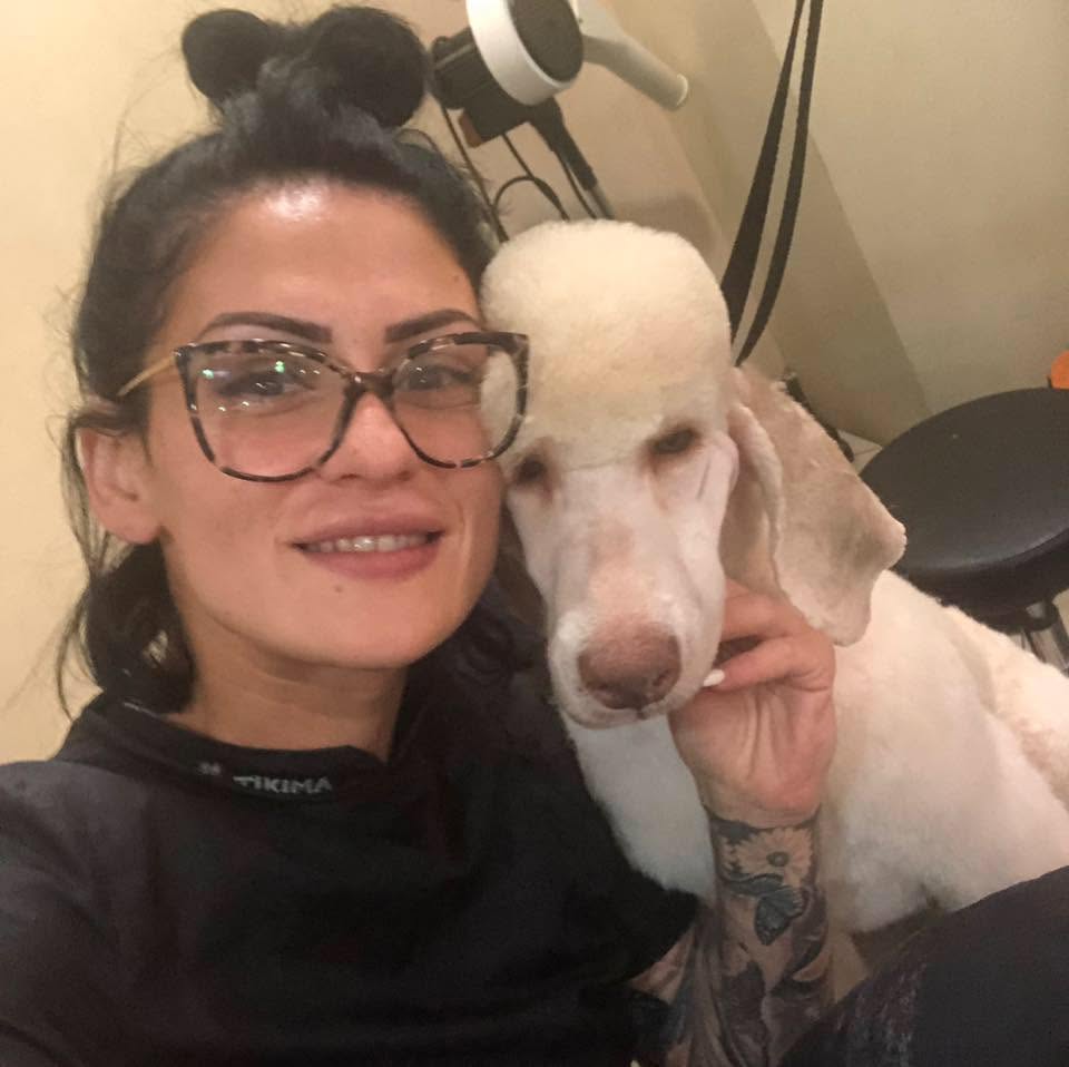 Michelle with a freshly groomed poodle